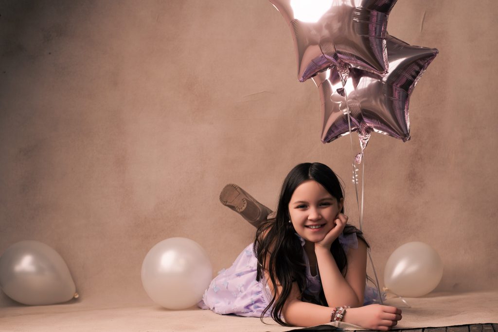 girl holding balloons during her birthday photoshoot in syracuse ny